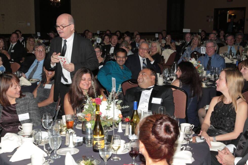 Al Skinner performing close-up magic at a black tie dinner in Sacramento