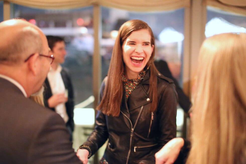Guest reacting to a close-up magic trick at a company event