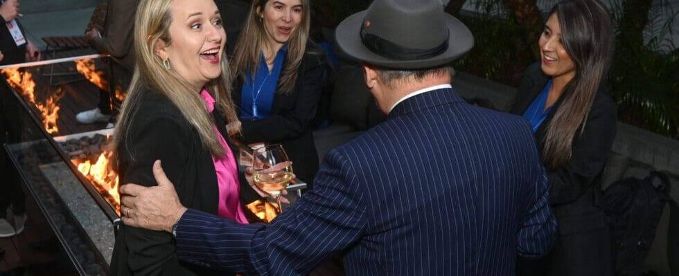 Guests laughing during strolling magic at a Sacramento corporate reception